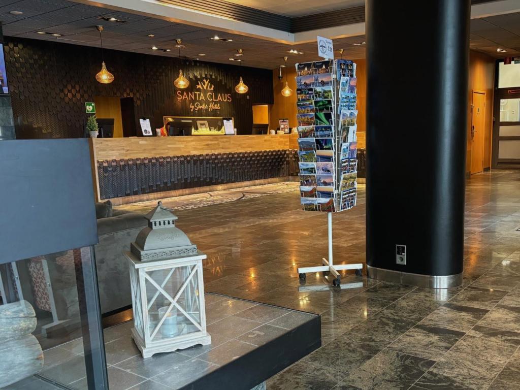 a restaurant with a light in the middle of a lobby at Santa's Hotel Santa Claus in Rovaniemi