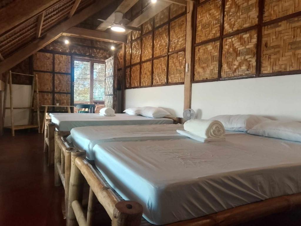 Postel nebo postele na pokoji v ubytování Coleto Siargao