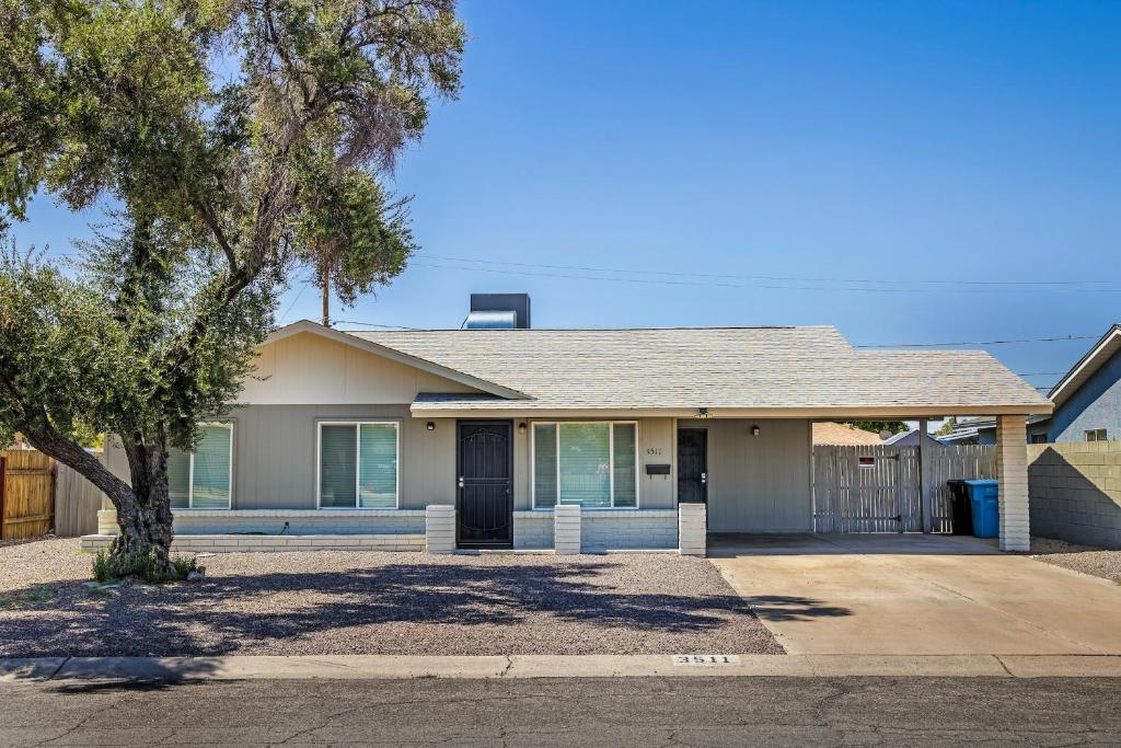 a house with a tree in front of it at Cozy 3BR House Near Attractions & Shopping in Phoenix