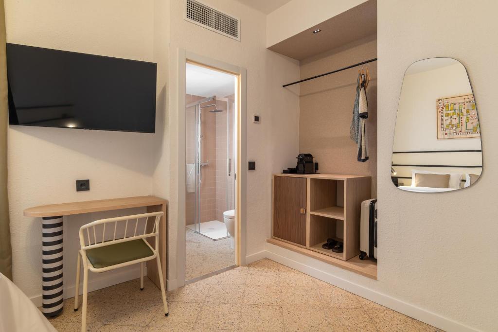 a room with a bathroom with a sink and a mirror at Hotel Robson - Smart Hotel in Lloret de Mar
