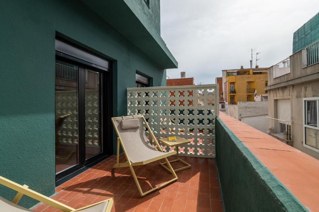 a chair sitting on the balcony of a building at Hotel Robson - Smart Hotel in Lloret de Mar