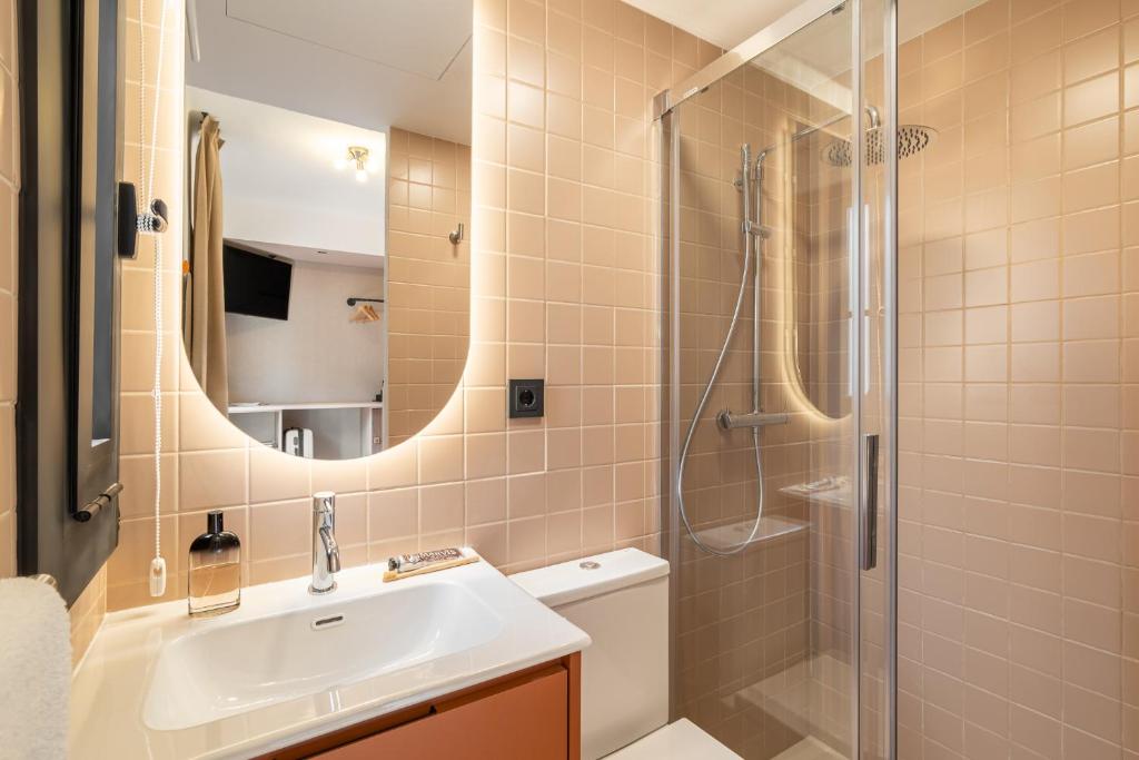 a bathroom with a sink and a shower at Hotel Robson - Smart Hotel in Lloret de Mar