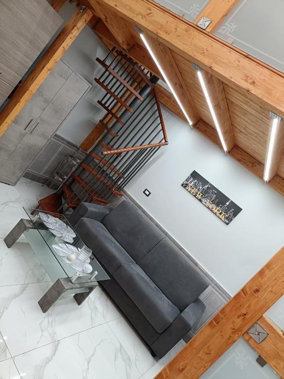 an overhead view of a living room with a couch and a staircase at Maison Chic in Ercolano