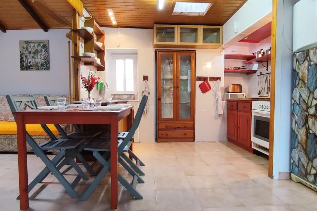 a kitchen with a wooden table and chairs at A Riquiña in Mondariz