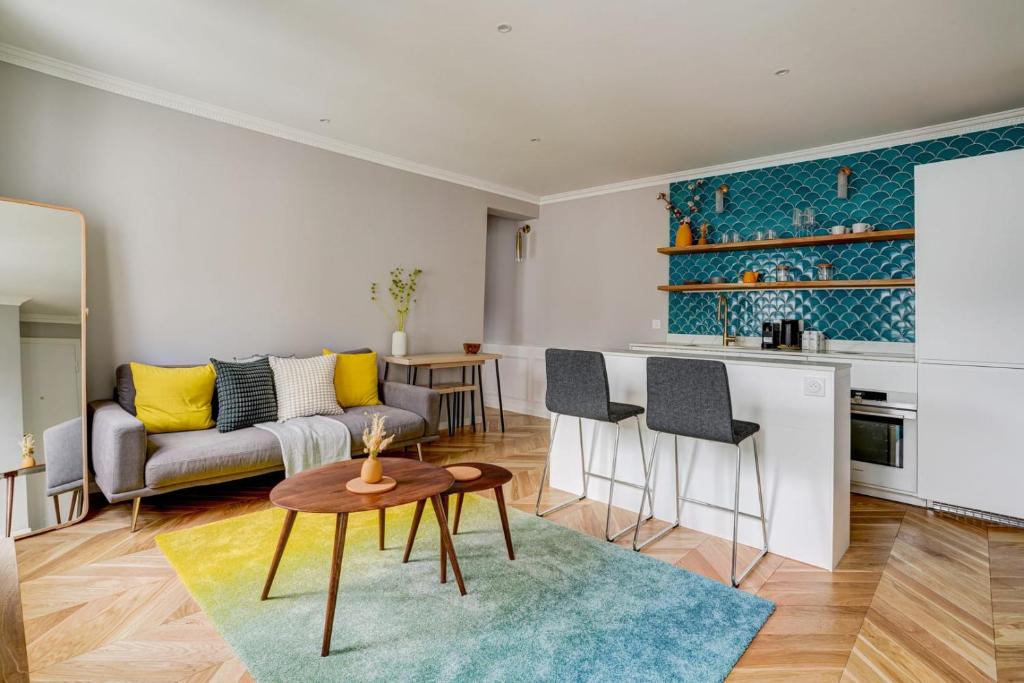un salon avec un canapé et une table dans l'établissement SaintGermain Sojourn - Charming 2 bedroom in the Rive Gauche, à Paris
