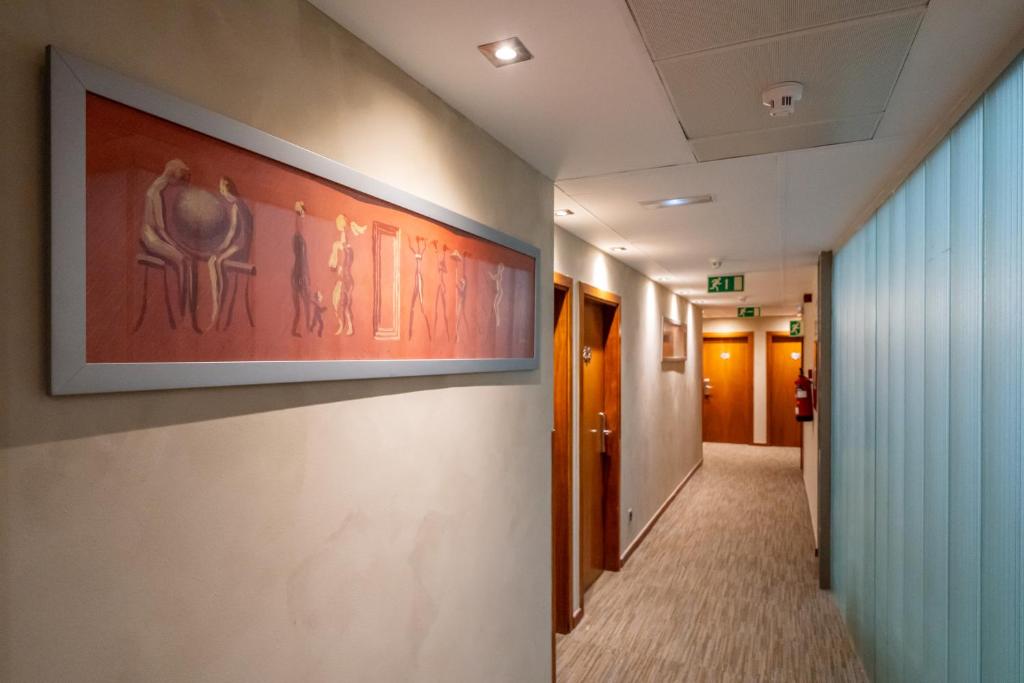 a hallway in a hospital with a painting on the wall at Abba Rambla Hotel in Barcelona