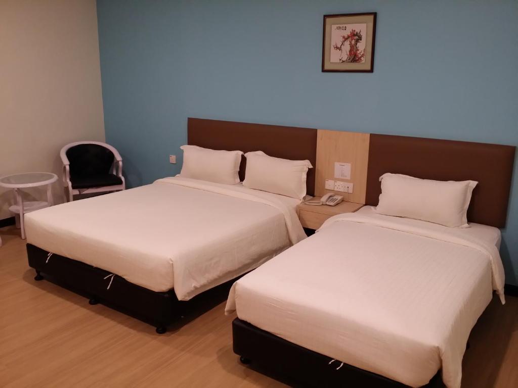 Postel nebo postele na pokoji v ubytování MJ Hotel