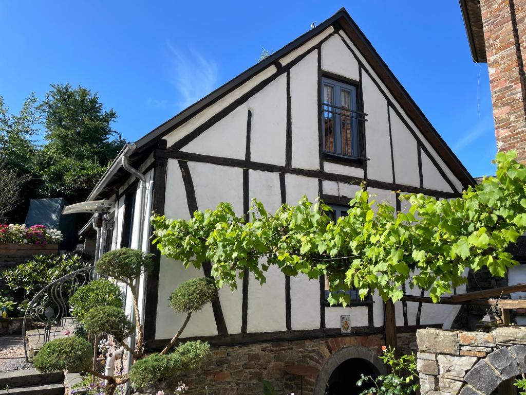 an old black and white building with a window at Ferienhaus Romantica in Bruttig-Fankel für 2 Personen in Bruttig-Fankel