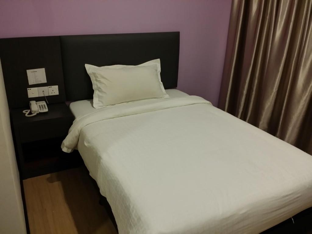 Postel nebo postele na pokoji v ubytování MJ Hotel