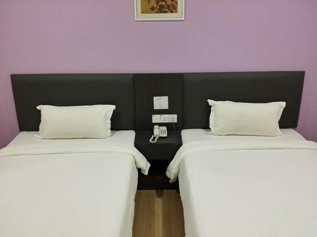 Postel nebo postele na pokoji v ubytování MJ Hotel
