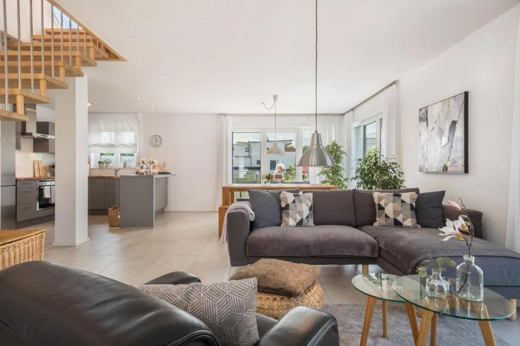 a living room with a couch and a table at Time Out - Appartement Bodensee in Friedrichshafen
