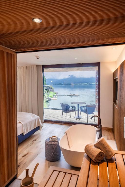 a bedroom with a view of the ocean at Hotel Seevilla Wolfgangsee in St. Wolfgang