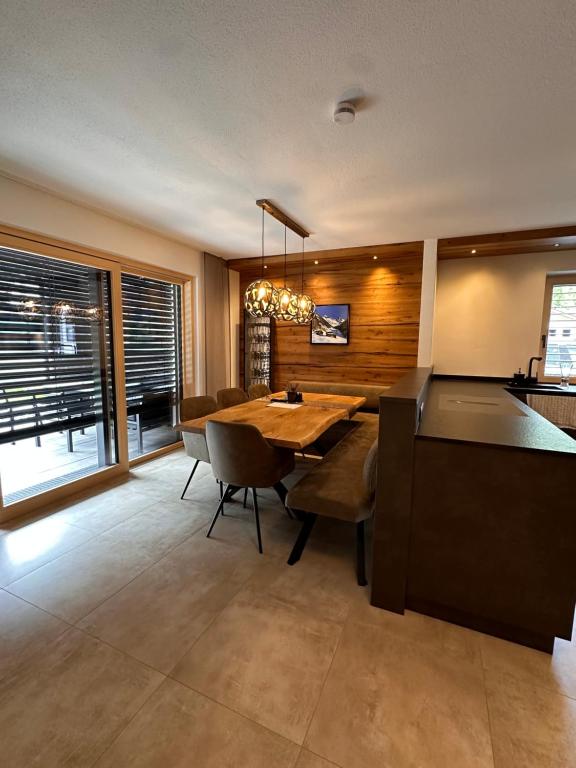 a dining room with a wooden table and chairs at Chalet Waldele in Sölden
