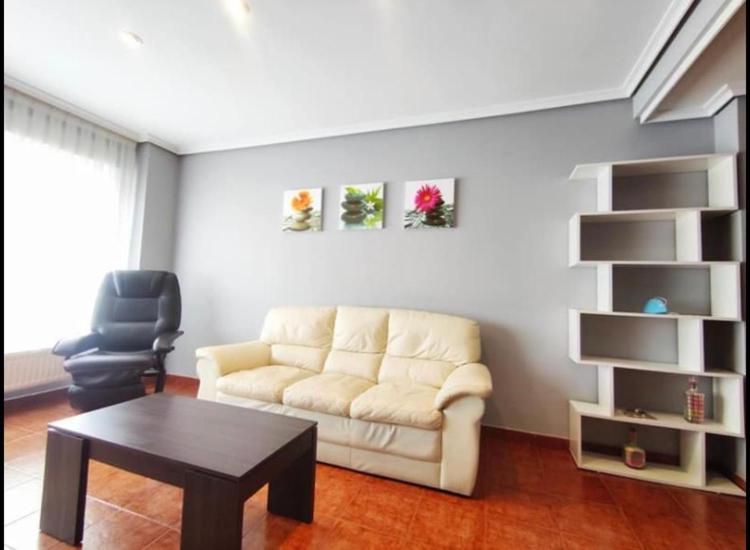 a living room with a couch and a table at ApartamentoDJ in Suances