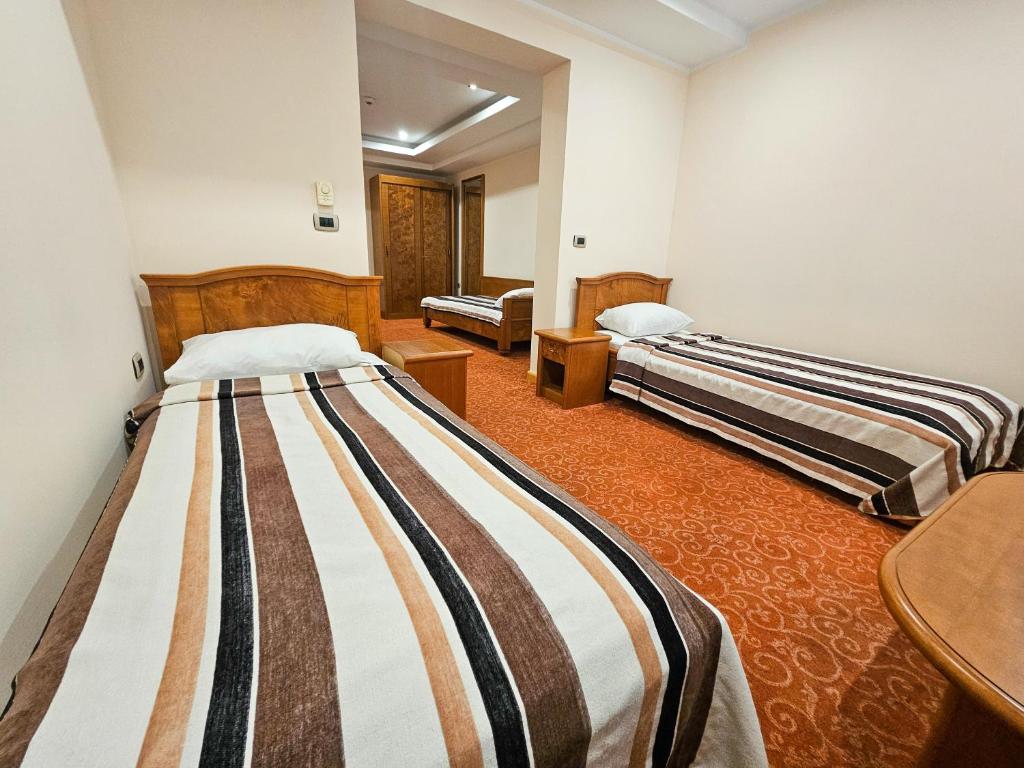 Postel nebo postele na pokoji v ubytování Mali Hotel BaMBiS