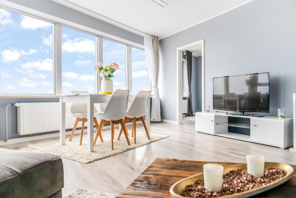 a living room with a table and chairs and a tv at Schleswiger Ausblick in Schleswig
