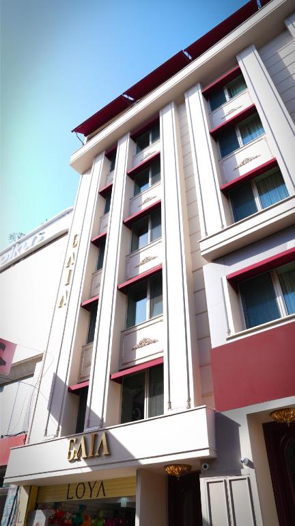 a tall white building with a sign on it at Gaia Suites Istanbul in Istanbul