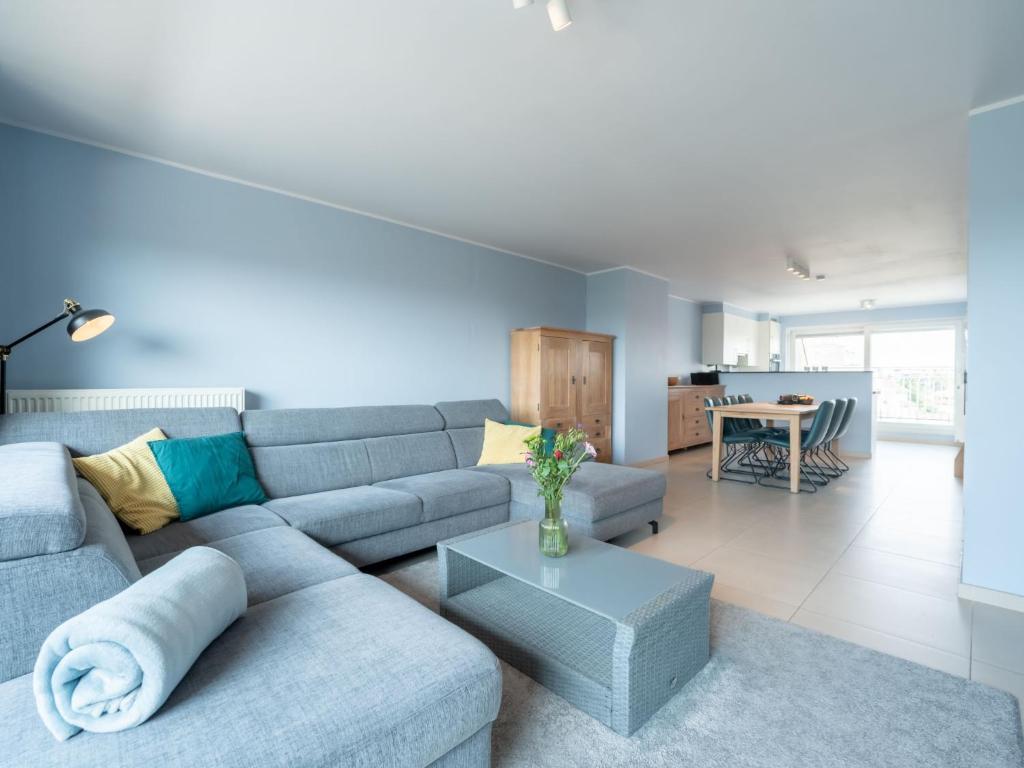 a living room with a couch and a table at Apartment Parklane-3 by Interhome in Bredene