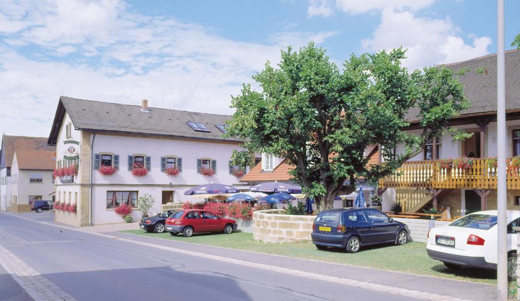 a street with cars parked in front of a building at Gasthof Krapp in Litzendorf