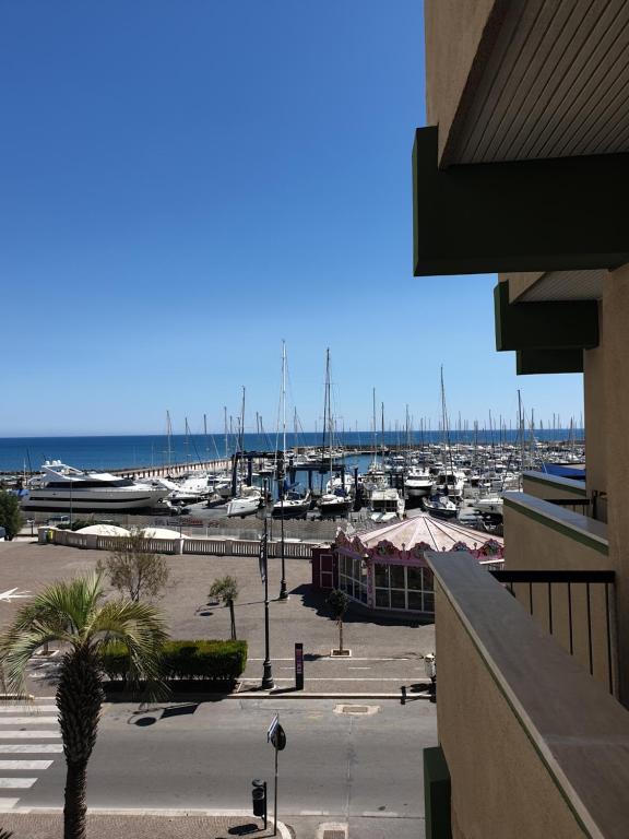 a marina with boats parked in a parking lot at Nettuno apartment city center sea view in Nettuno