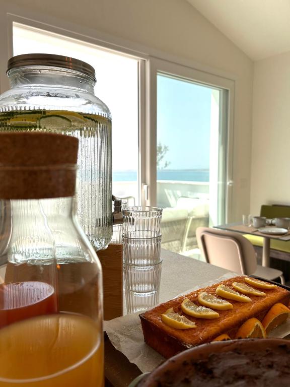 a jar of honey and a plate of food on a table at Vireo Rooms in Santa Maria Navarrese