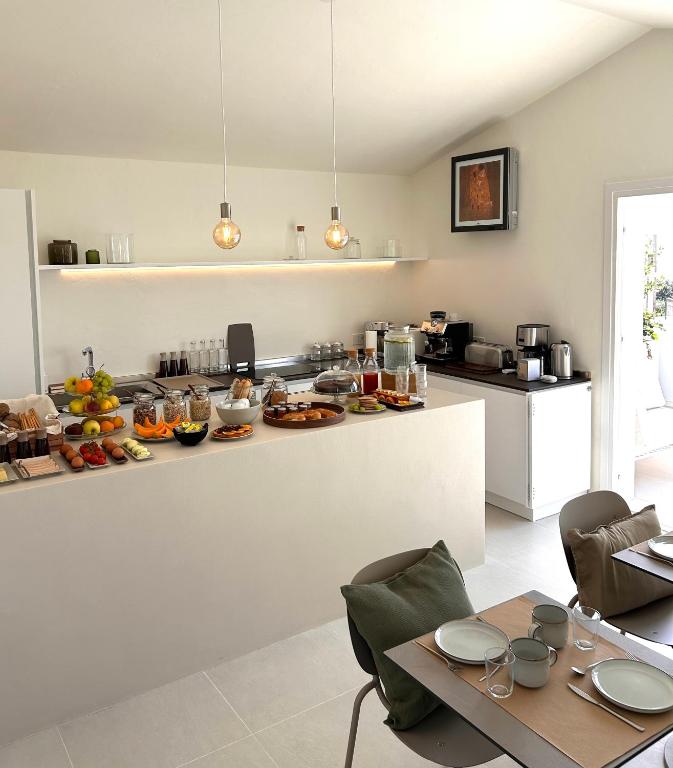 a kitchen with a counter with food on it at Vireo Rooms in Santa Maria Navarrese