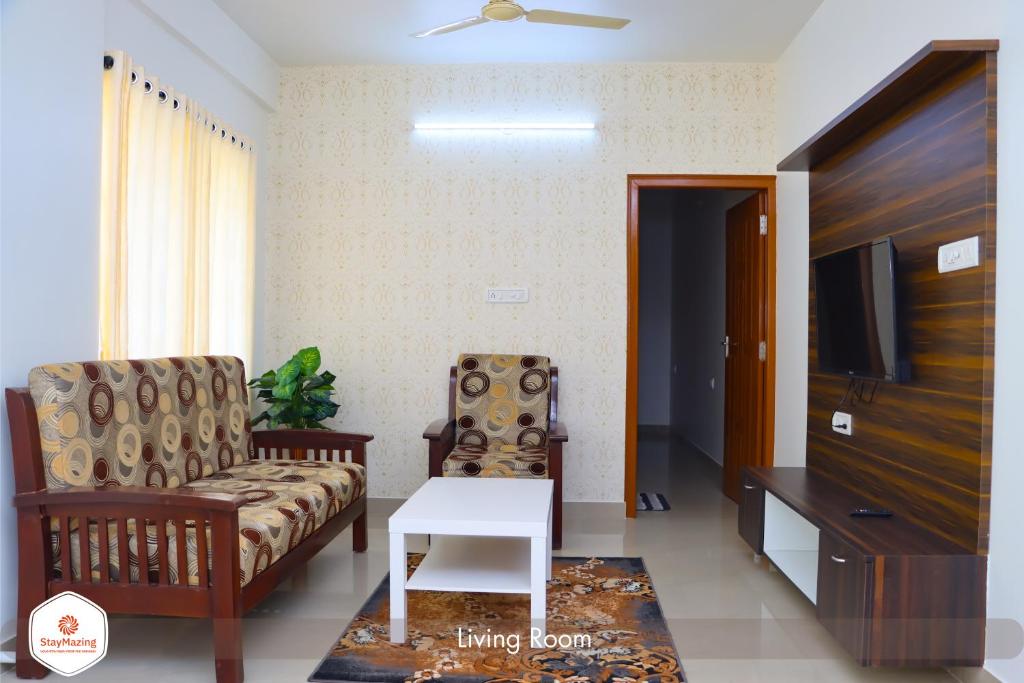 a living room with a couch and a tv at Staymazing Ferndale-1 & 2 BHK Boutique AC Serviced Apartments in Bengaluru