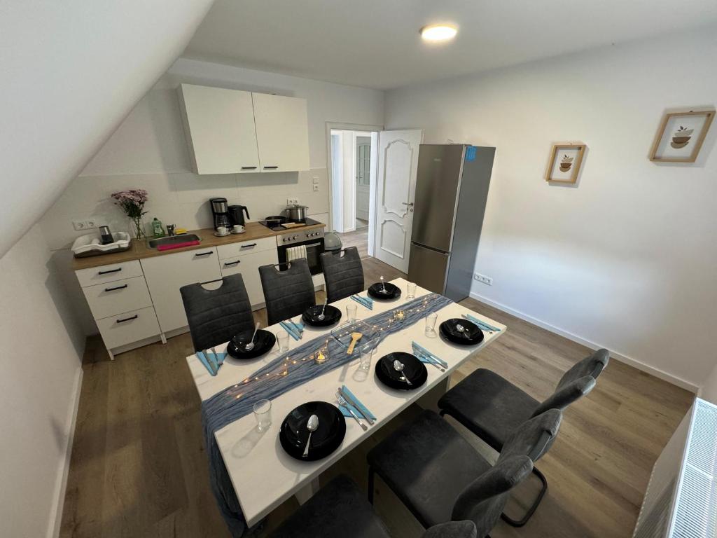 a kitchen with a table and chairs in a room at Big House I 15 Beds I 8 Sleeping Room I Parking in Bad Oeynhausen