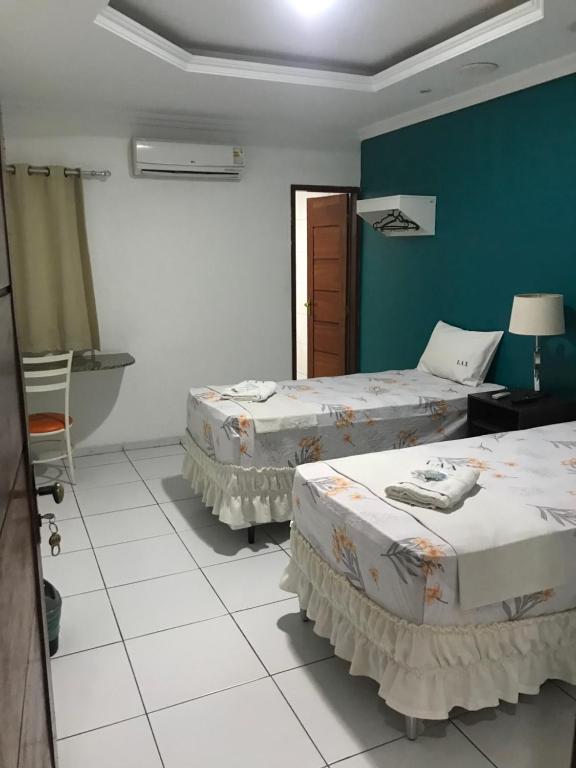 Postel nebo postele na pokoji v ubytování Lax Hotel - Acesso através de escadas - 3 andares