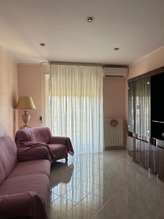 a living room with a couch and a flat screen tv at Appartamento Polisnea in Polignano a Mare