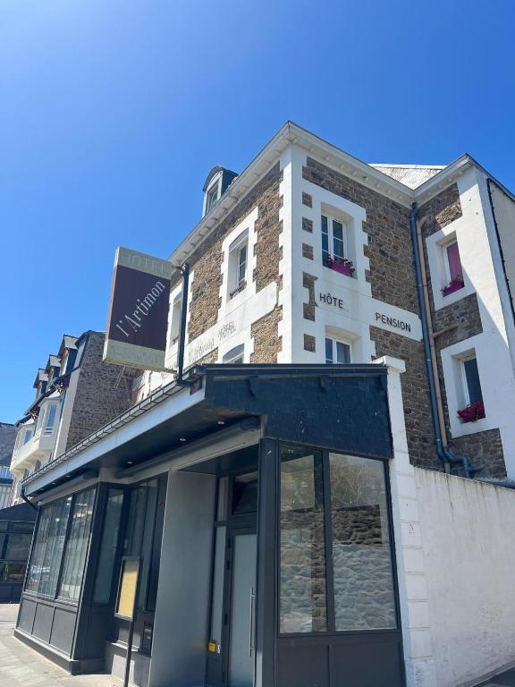 a building with a sign on the front of it at L'Artimon by les Ambassadeurs - Saint Malo Plage in Saint Malo