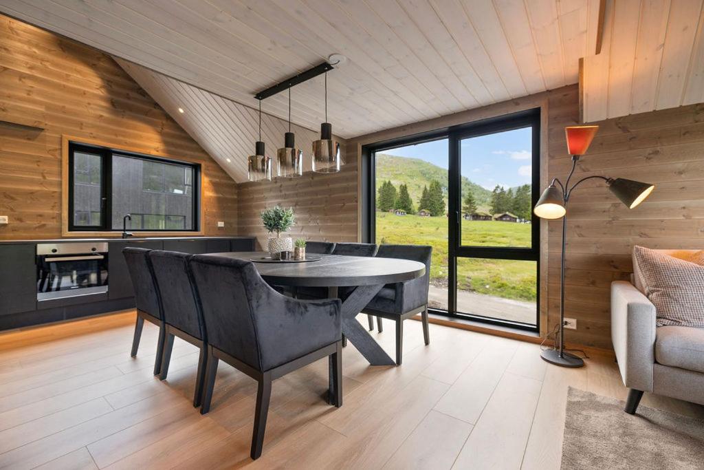 a kitchen and dining room with a table and chairs at Mountain View Apartment - penthouse in Stranda
