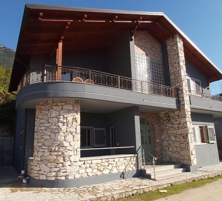 a large building with a balcony on top of it at Countryside house in Vlorë