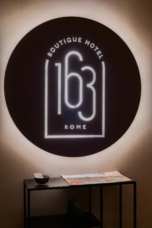 a black and white sign on a wall at 163 BOUTIQUE HOTEL in Rome