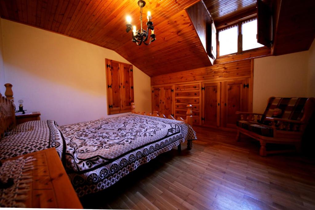 a bedroom with a bed and a window and a chair at Ferrata Vacanze in Rhêmes-Notre-Dame