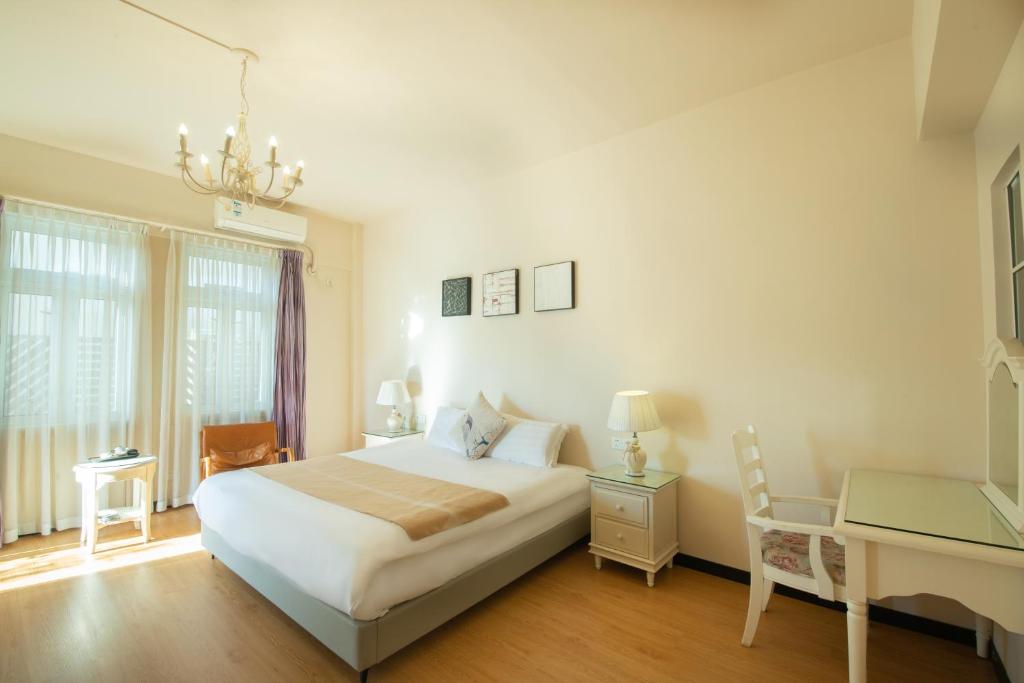 Postel nebo postele na pokoji v ubytování 厦门鼓浪屿湾景酒店