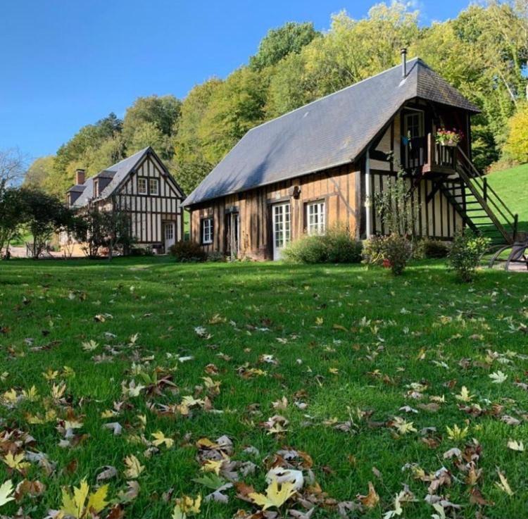 a house in a field with leaves in the grass at BnB Golden Delicious for 2 in Normandy in Les Champeaux