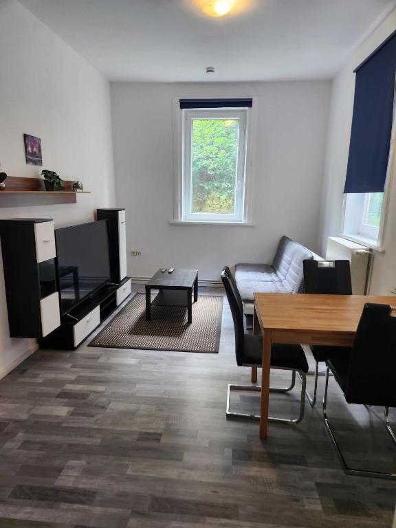 a living room with a couch and a table at Monteurwohnungen Lerbachtal in Osterode