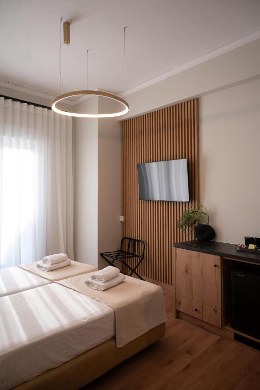 Postel nebo postele na pokoji v ubytování Eudokia Pension