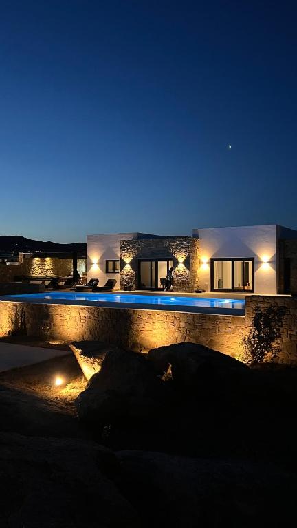 a house at night with blue lights on it at Villa Taiyo Mykonos in Mikonos