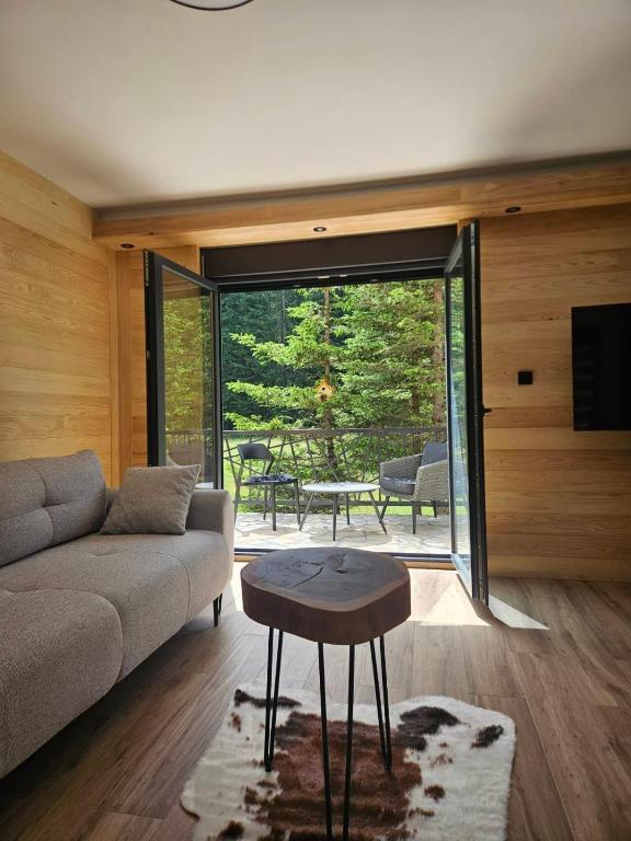 a living room with a couch and a table at Forest Fox in Žabljak