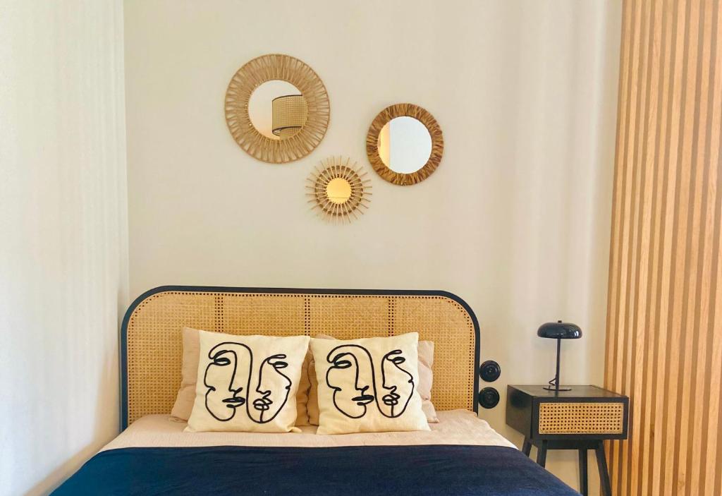 a bedroom with a bed with two mirrors on the wall at AK Apartments 2 in Warsaw