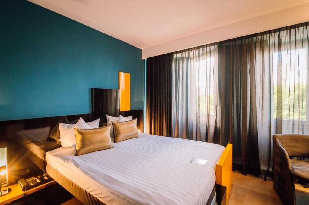 Postel nebo postele na pokoji v ubytování Plaza V Hotel