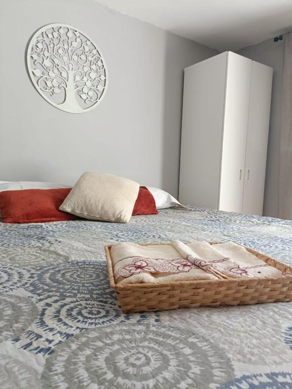 a bedroom with a bed with a basket on it at La Rueda, campo y playa en el Medano in El Médano