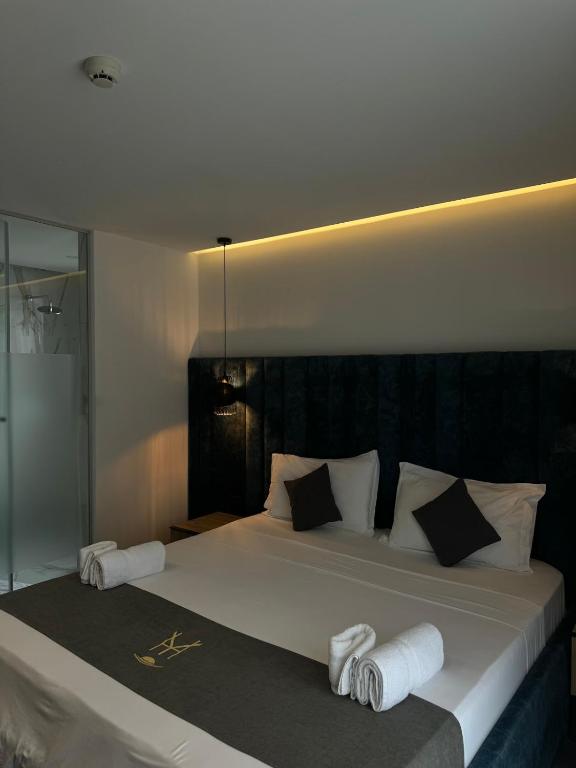 a bedroom with a large bed with towels on it at HOTEL BAR RESTORANT YLLI in Shëngjin