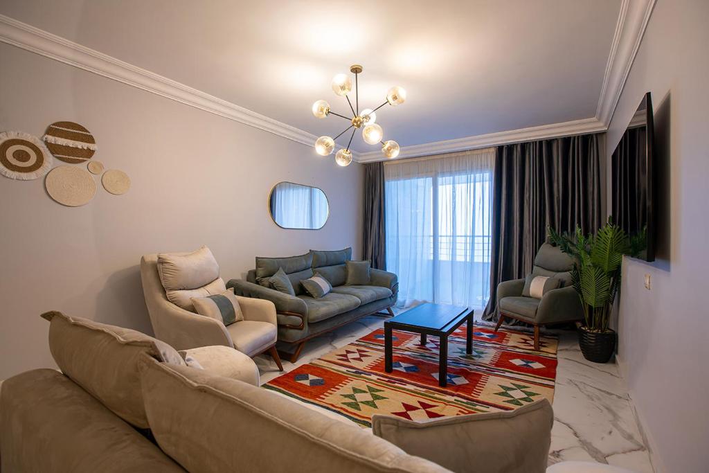a living room with a couch and chairs and a table at Skyline Premium Properties in Alexandria