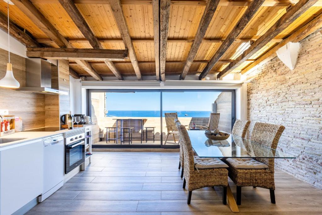 a kitchen with a dining table and a view of the ocean at Panoramic by Unik Vacation in Tarragona