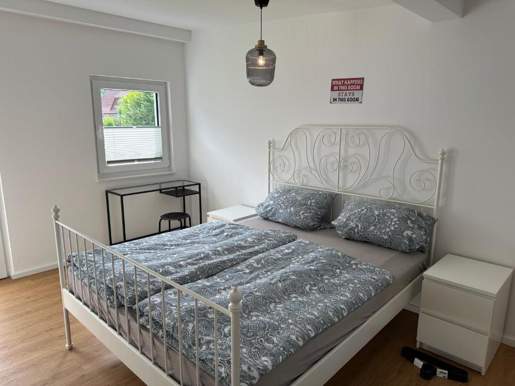 a bedroom with a bed with a metal bed frame at Villa Frankenstein - Deluxe Ferienwohnung mit Ladestation E-Auto & E-Bike in Lancken-Granitz