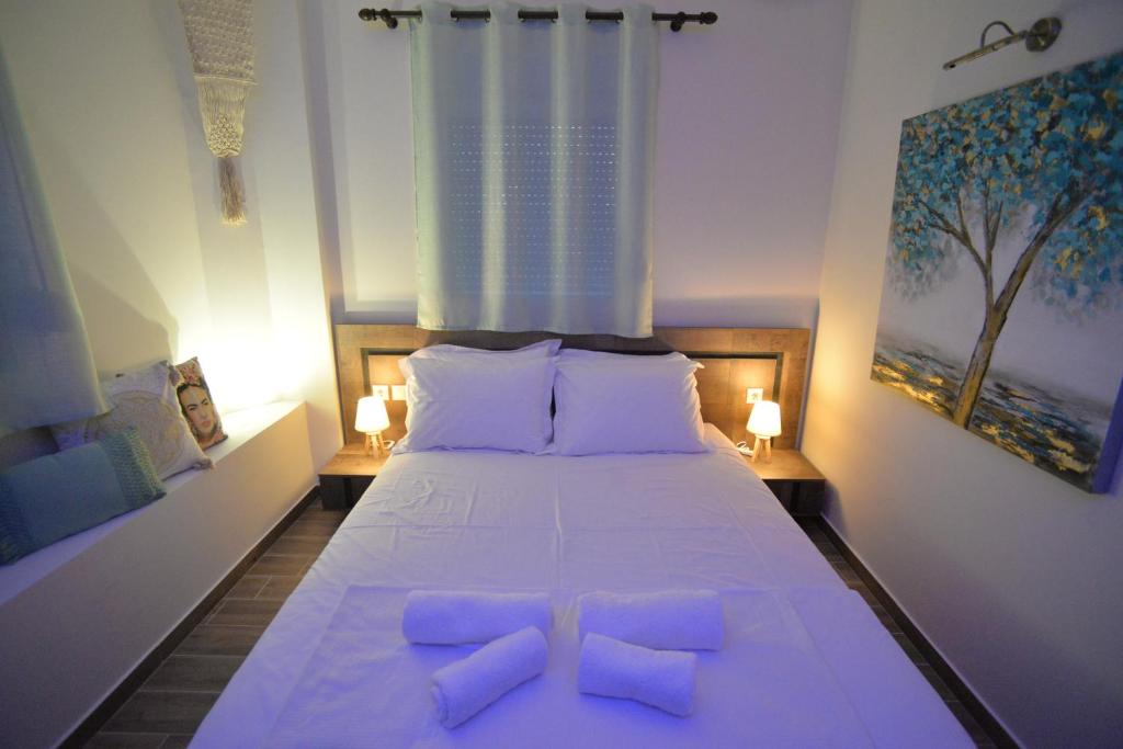 a bedroom with a large white bed with two pillows at Casa Nostra in Litochoro