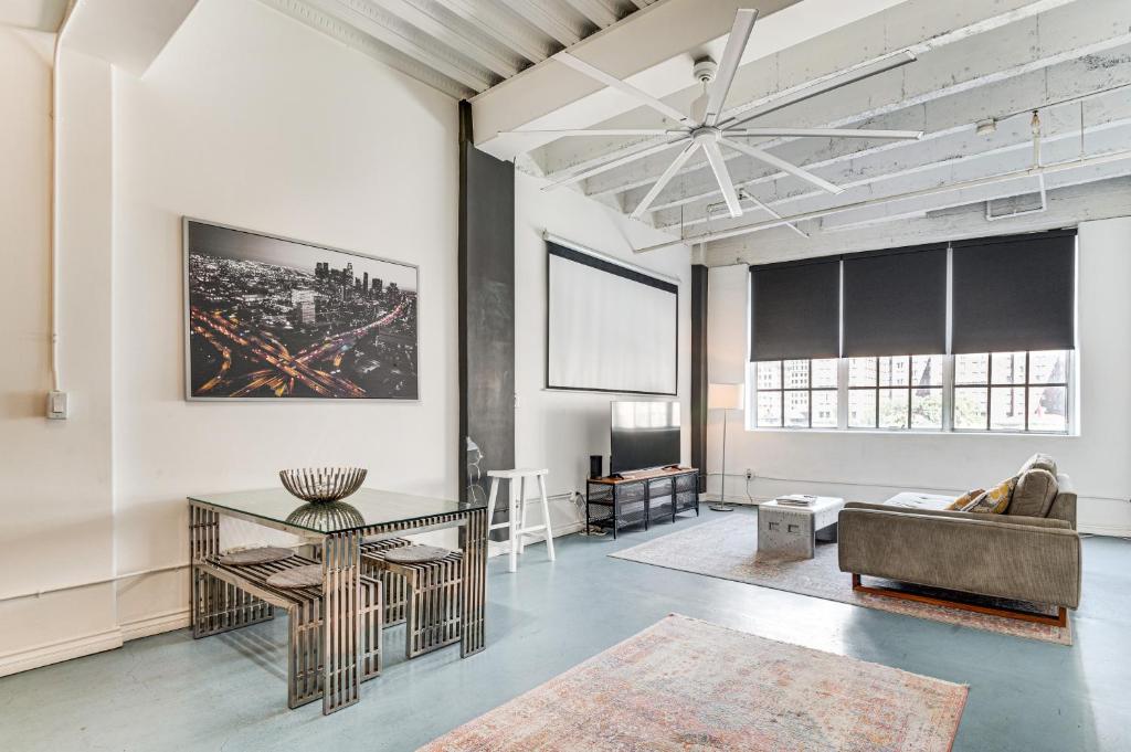 a living room with a table and a couch at Downtown Los Angeles Condo with Rooftop Pool Access in Los Angeles